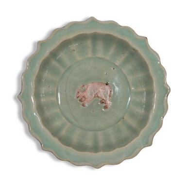 An exceedingly rare biscuit-reserved barbed-rim 'Longquan' celadon-glazed 'bear' dish, Yuan dynasty, Yanyou reign, corresponding to 1314-1320